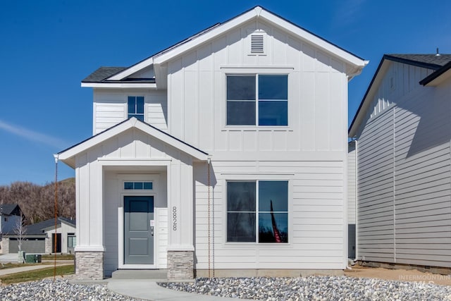 modern inspired farmhouse with a garage