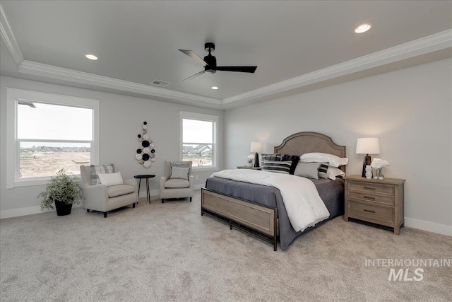 bedroom with light colored carpet, a raised ceiling, ceiling fan, and ornamental molding