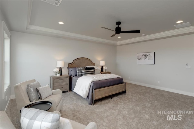 bedroom featuring ceiling fan, a raised ceiling, light colored carpet, and crown molding