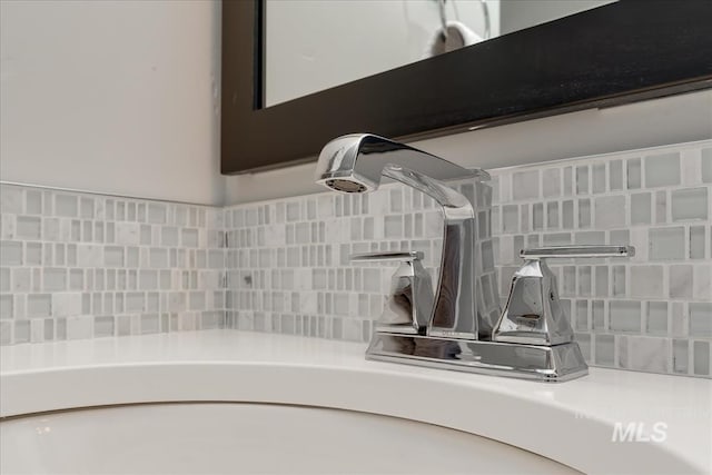 room details featuring tasteful backsplash and sink