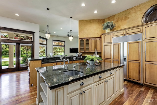 2634 W Sugarberry Dr, Eagle, ID 83616 - kitchen with a sink, paneled built in refrigerator, a kitchen island with sink, dark wood finished floors, and dark stone countertops