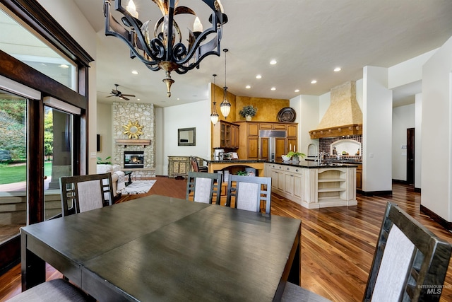 2634 W Sugarberry Dr, Eagle, ID 83616 - dining room featuring a fireplace, recessed lighting, ceiling fan, a chandelier, and dark wood finished floors