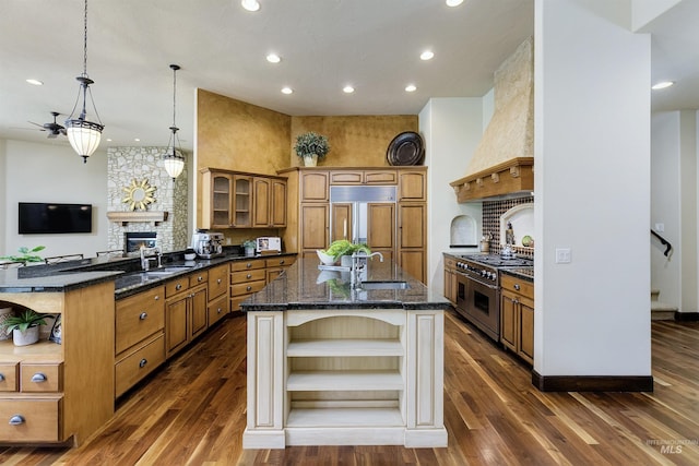 2634 W Sugarberry Dr, Eagle, ID 83616 - kitchen with open shelves, recessed lighting, premium appliances, brown cabinets, and an island with sink