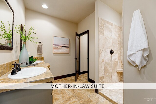 2634 W Sugarberry Dr, Eagle, ID 83616 - bathroom featuring walk in shower, double vanity, baseboards, and recessed lighting