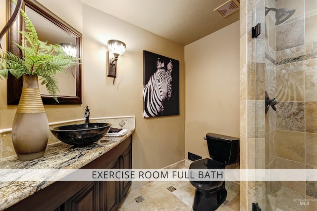 2634 W Sugarberry Dr, Eagle, ID 83616 - bathroom featuring a tile shower, vanity, and toilet