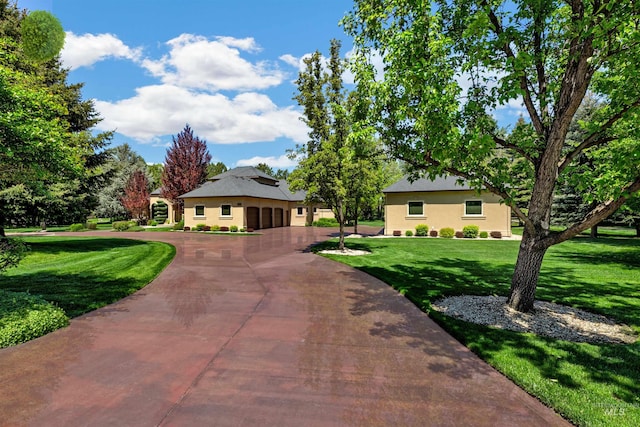 2634 W Sugarberry Dr, Eagle, ID 83616 - view of front of house with curved driveway, a front lawn, and stucco siding