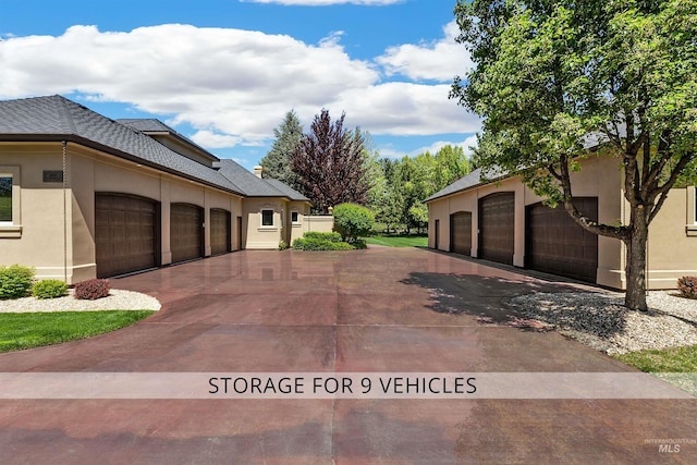 2634 W Sugarberry Dr, Eagle, ID 83616 - view of home's exterior featuring stucco siding, community garages, and a shingled roof