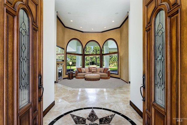 2634 W Sugarberry Dr, Eagle, ID 83616 - foyer featuring baseboards, inlaid floor details, light marble finish floors, ornamental molding, and a towering ceiling