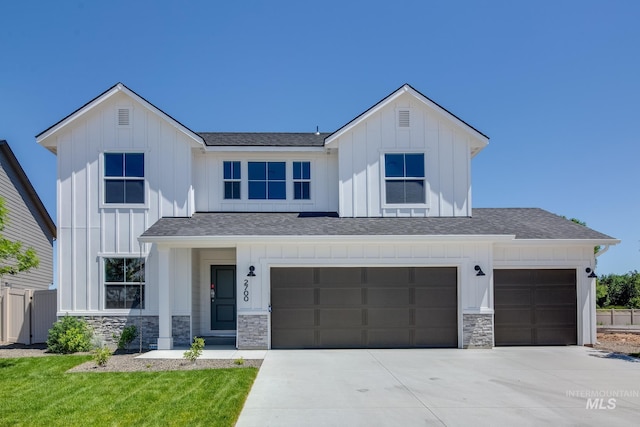 view of front of home with a garage and a front lawn