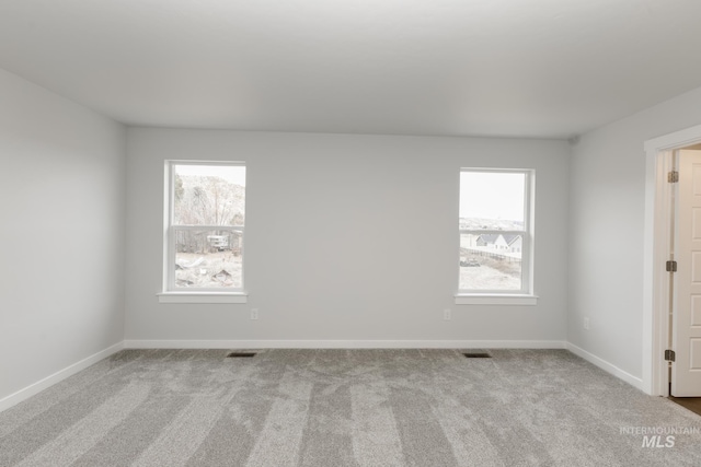 unfurnished room with light carpet