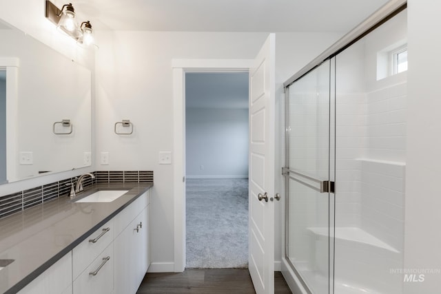 bathroom with vanity, wood-type flooring, and walk in shower