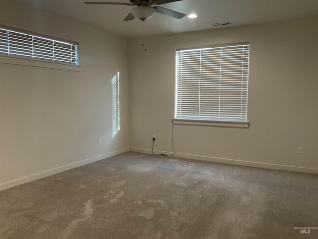 carpeted spare room with visible vents, recessed lighting, a ceiling fan, and baseboards