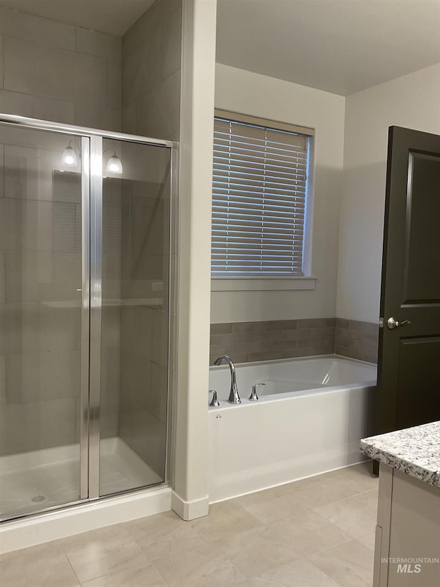 full bath featuring a bath, tile patterned flooring, a shower stall, and vanity