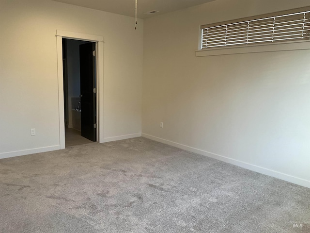 empty room with baseboards and carpet floors