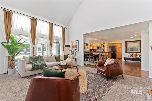 511 Keogh Ln, Caldwell, ID 83607 - living area with light colored carpet, a chandelier, high vaulted ceiling, baseboards, and recessed lighting