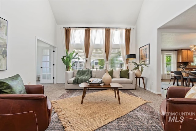 511 Keogh Ln, Caldwell, ID 83607 - living room with light carpet, high vaulted ceiling, and baseboards