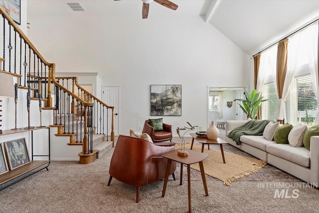 511 Keogh Ln, Caldwell, ID 83607 - carpeted living room featuring high vaulted ceiling, a ceiling fan, stairs, beamed ceiling, and baseboards