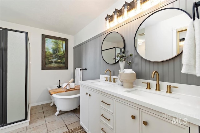 511 Keogh Ln, Caldwell, ID 83607 - bathroom featuring double vanity, tile patterned floors, a shower stall, a soaking tub, and baseboards