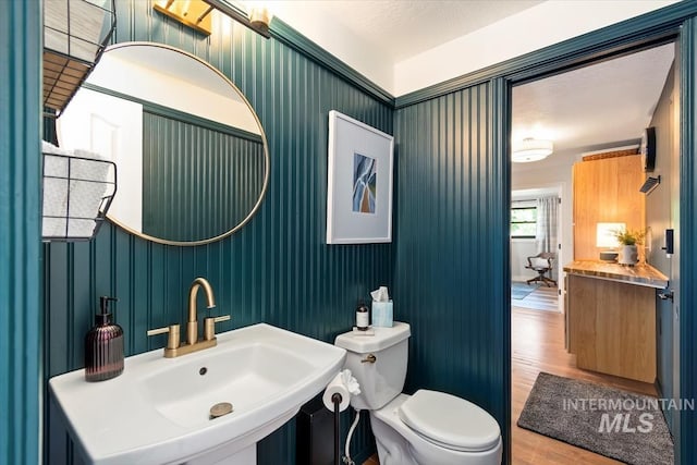 511 Keogh Ln, Caldwell, ID 83607 - half bathroom with wood finished floors, toilet, and a sink