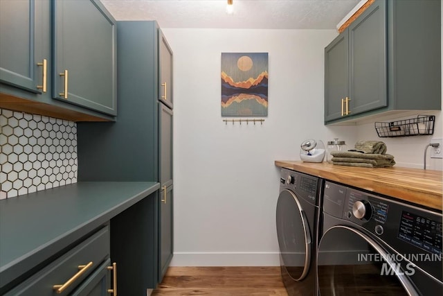 511 Keogh Ln, Caldwell, ID 83607 - washroom with washing machine and dryer, cabinet space, baseboards, and light wood finished floors