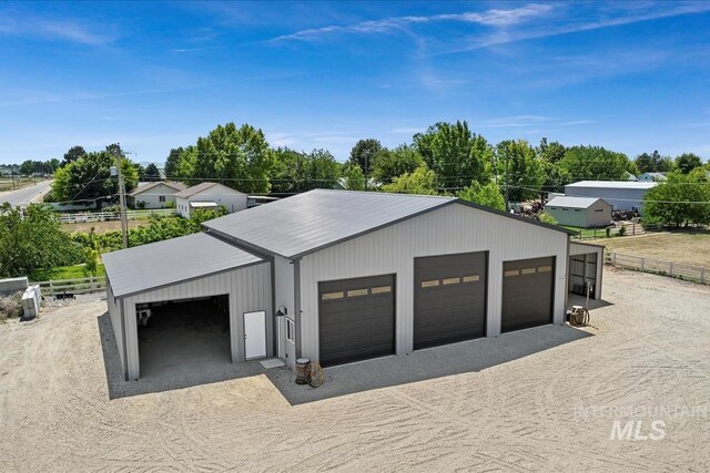 511 Keogh Ln, Caldwell, ID 83607 - detached garage with dirt driveway and view of scattered trees
