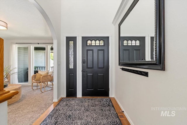 511 Keogh Ln, Caldwell, ID 83607 - entrance foyer with arched walkways, wood finished floors, and baseboards