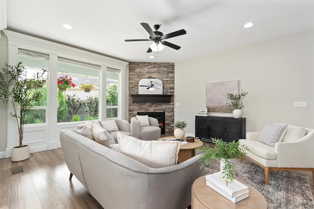 5404 S Palatino Ave, Meridian, ID 83642 - living area with wood finished floors, a stone fireplace, a ceiling fan, and recessed lighting