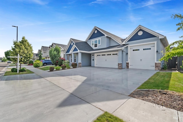 5404 S Palatino Ave, Meridian, ID 83642 - view of front of home with a garage, concrete driveway, and stone siding
