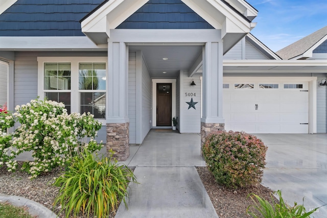 5404 S Palatino Ave, Meridian, ID 83642 - property entrance with an attached garage, stone siding, and driveway