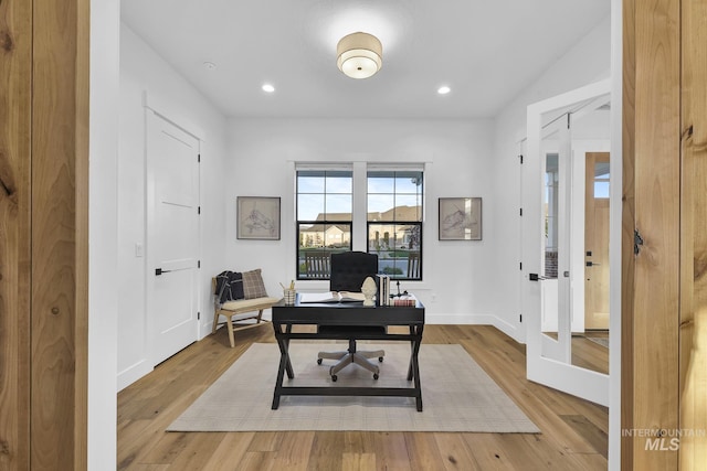 office space with light wood finished floors, recessed lighting, and baseboards