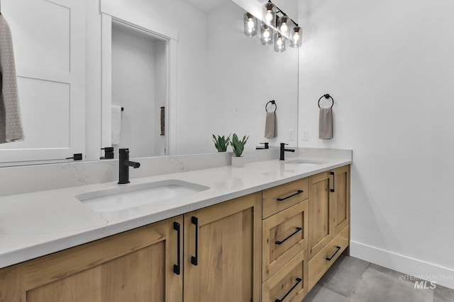 full bathroom featuring double vanity and baseboards