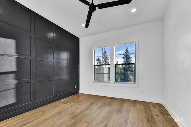 spare room featuring ceiling fan, baseboards, light wood finished floors, and recessed lighting