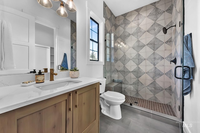 bathroom with a stall shower, tile patterned floors, toilet, and vanity