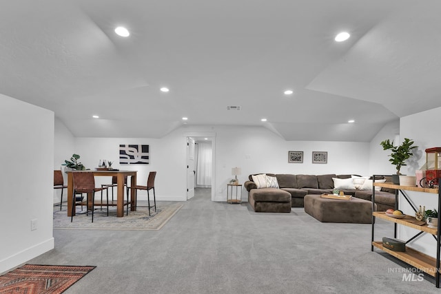 carpeted living area featuring recessed lighting and baseboards