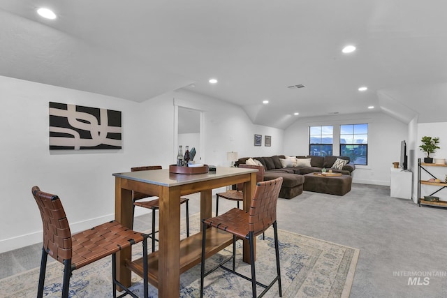 carpeted dining area with recessed lighting, baseboards, and lofted ceiling