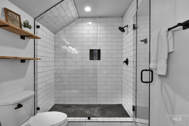 bathroom with toilet and a shower stall