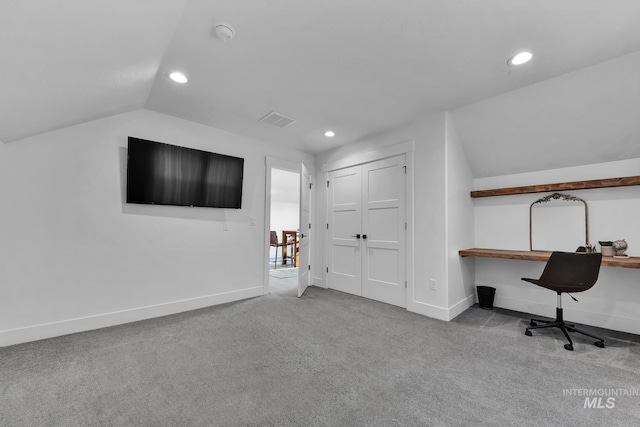 carpeted home office with recessed lighting, lofted ceiling, built in desk, and baseboards