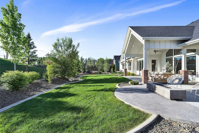 view of yard with a ceiling fan and a patio area