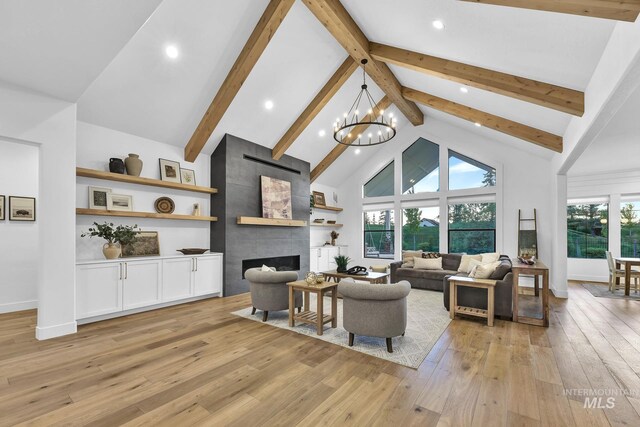 living room featuring high vaulted ceiling, light wood-type flooring, beamed ceiling, recessed lighting, and a chandelier