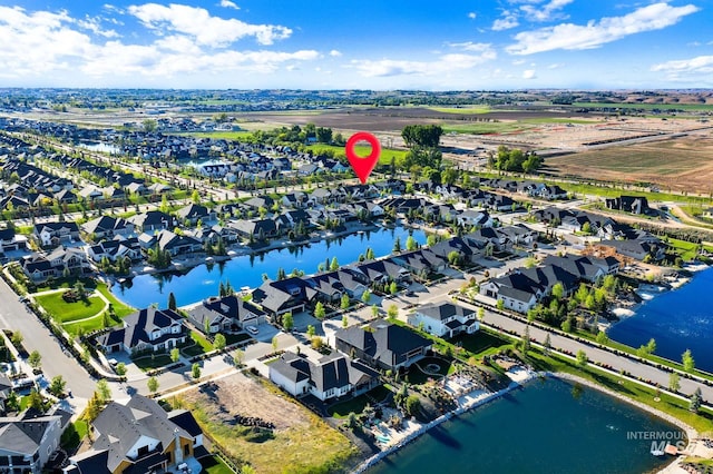 aerial overview of property's location featuring a nearby body of water and nearby suburban area