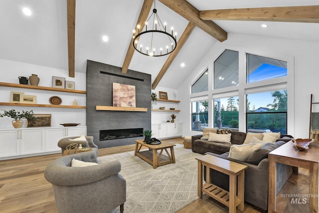 living room featuring high vaulted ceiling, light wood-style floors, beam ceiling, a chandelier, and a tiled fireplace