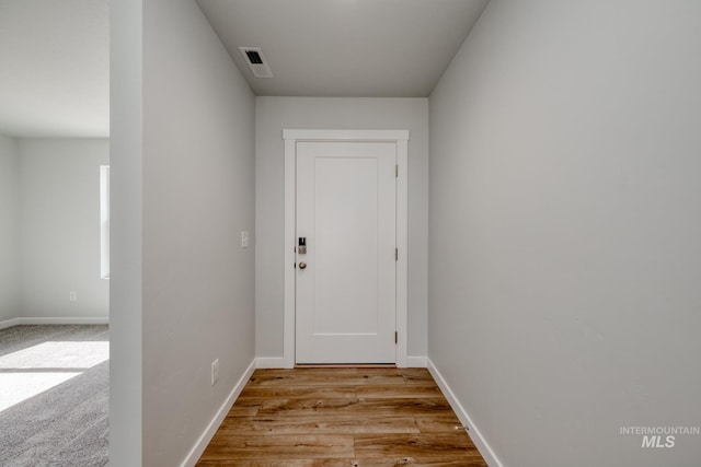 entryway featuring baseboards and light wood-type flooring