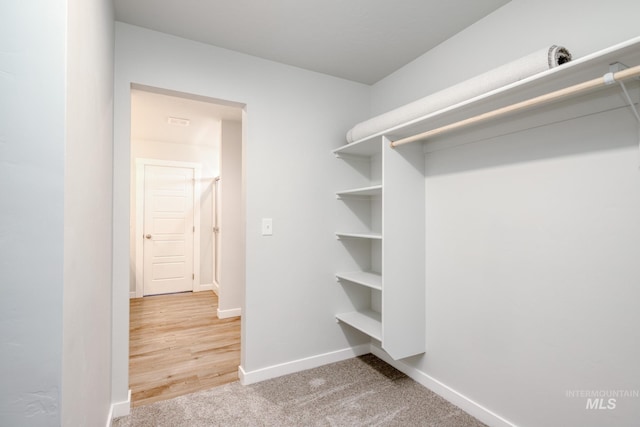 walk in closet with carpet