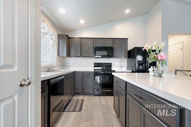 11616 Virginia Pkwy, Caldwell, ID 83605 - kitchen with black appliances, a sink, vaulted ceiling, light countertops, and light wood-style flooring