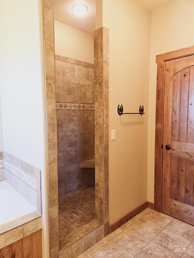 bathroom with tile patterned floors and shower with separate bathtub