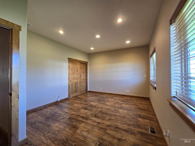 unfurnished bedroom with dark hardwood / wood-style flooring