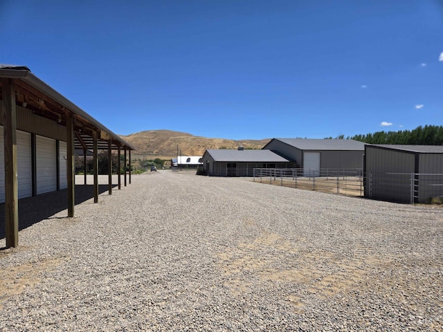 view of yard featuring a mountain view and an outbuilding