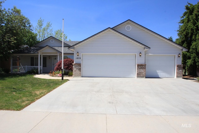 single story home with an attached garage, brick siding, and concrete driveway