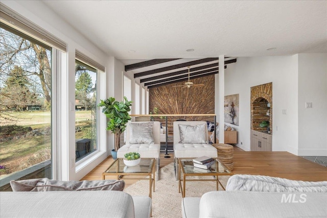 sunroom / solarium with lofted ceiling with beams