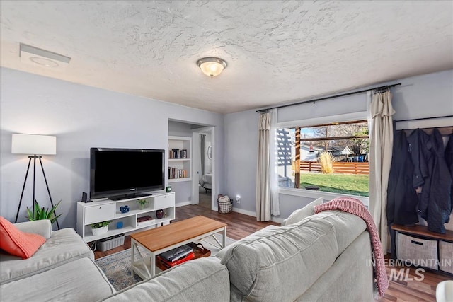 living room featuring a textured ceiling and hardwood / wood-style flooring